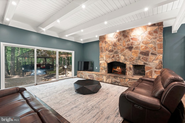 living room with beam ceiling, a fireplace, and hardwood / wood-style flooring