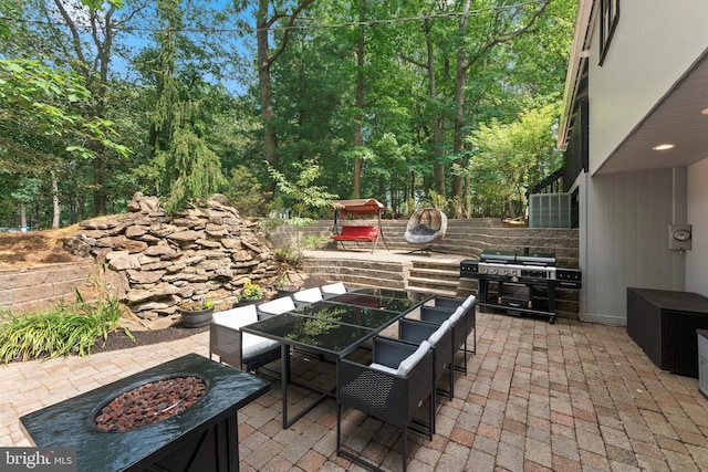 view of patio / terrace with grilling area and a fire pit