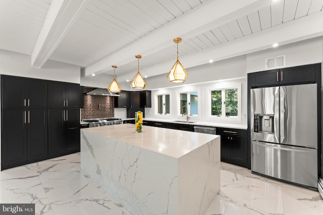 kitchen featuring tasteful backsplash, beamed ceiling, stainless steel appliances, pendant lighting, and a center island