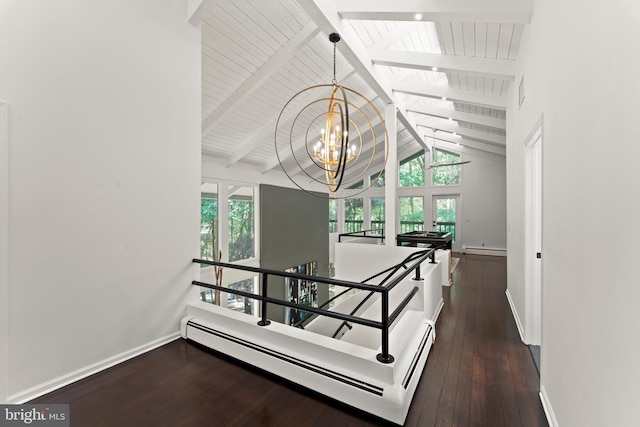 stairway featuring a notable chandelier, plenty of natural light, lofted ceiling with skylight, and dark hardwood / wood-style flooring