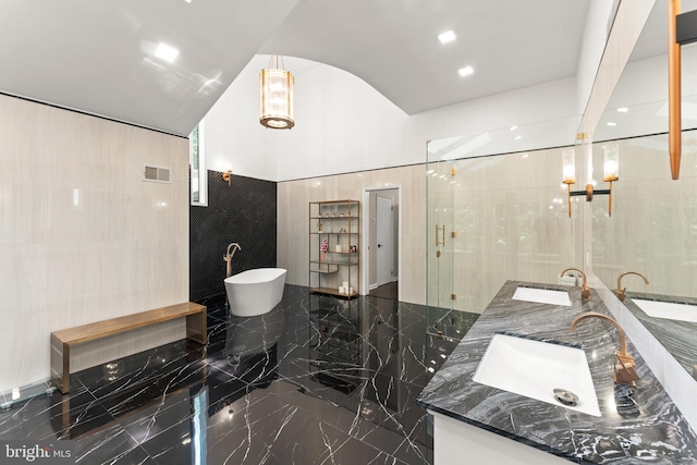 bathroom featuring dual vanity, an enclosed shower, tile walls, and tile floors