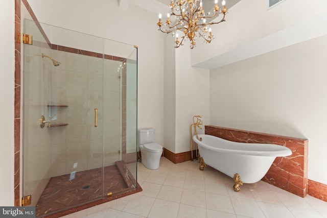 bathroom featuring tile floors, plus walk in shower, toilet, and a chandelier