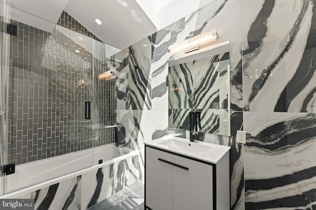 bathroom with lofted ceiling, combined bath / shower with glass door, and oversized vanity