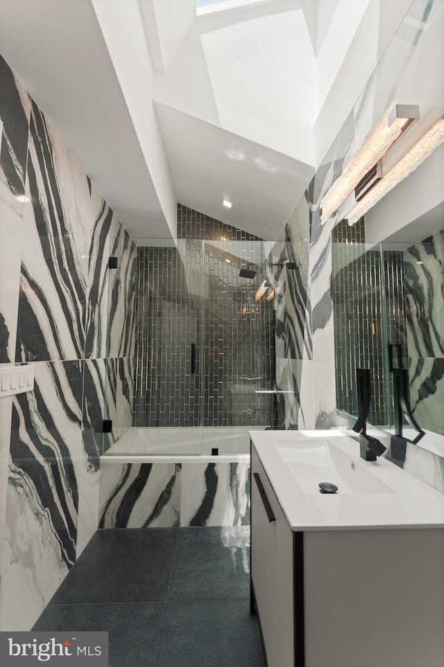 bathroom featuring a tile shower, tile flooring, and vanity