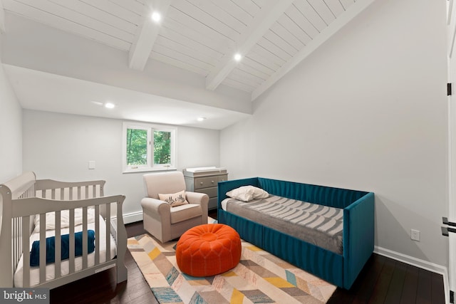 bedroom with lofted ceiling with beams and dark hardwood / wood-style flooring