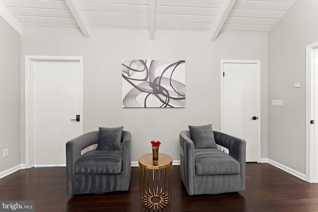 sitting room with beamed ceiling and dark wood-type flooring