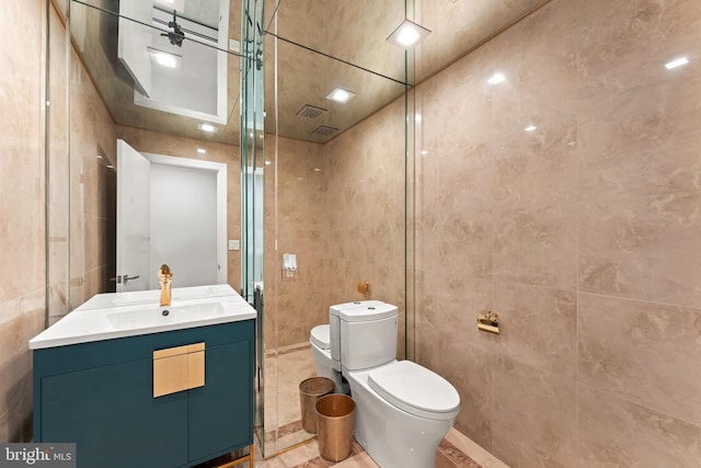 bathroom with tile flooring, an enclosed shower, tile walls, vanity, and toilet