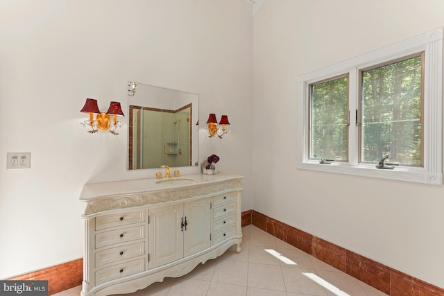 bathroom with tile floors, walk in shower, and vanity with extensive cabinet space