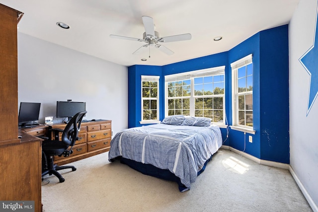 bedroom featuring ceiling fan and light carpet