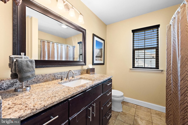 bathroom featuring vanity, toilet, and tile patterned flooring