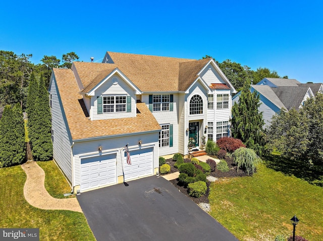 view of front of property featuring a garage and a front yard