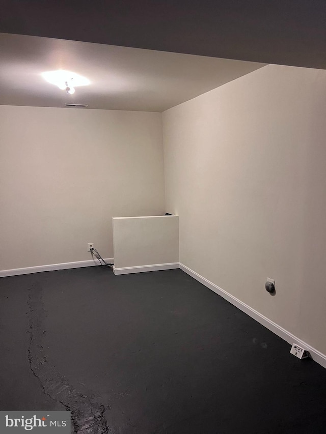 unfurnished room featuring concrete flooring