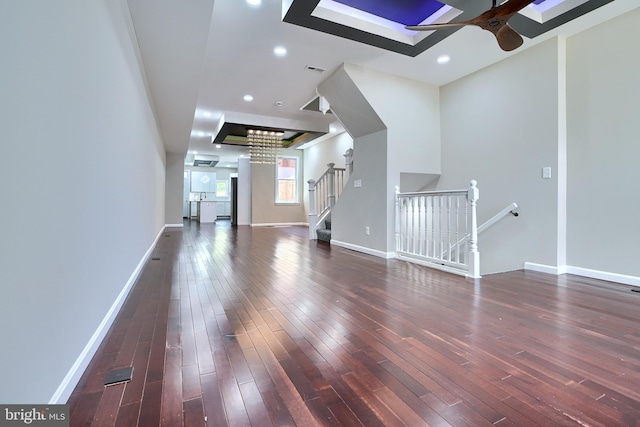 unfurnished living room with a chandelier and dark hardwood / wood-style flooring