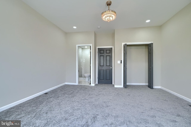 unfurnished bedroom featuring carpet flooring and ensuite bath