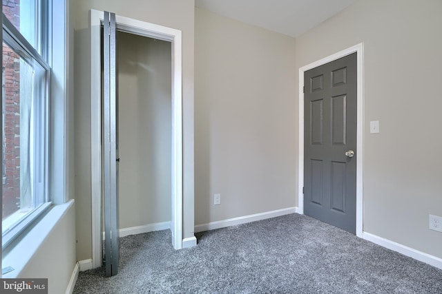 interior space with dark colored carpet