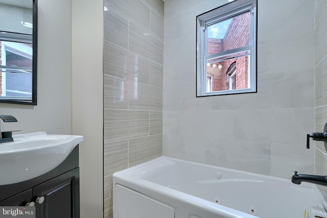 bathroom with a tub and vanity