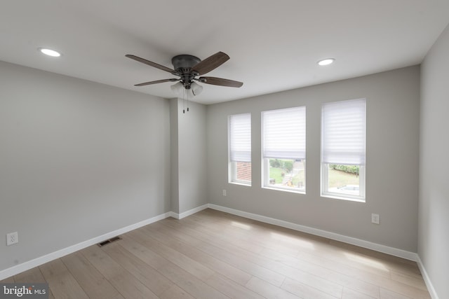 empty room with light hardwood / wood-style flooring and ceiling fan