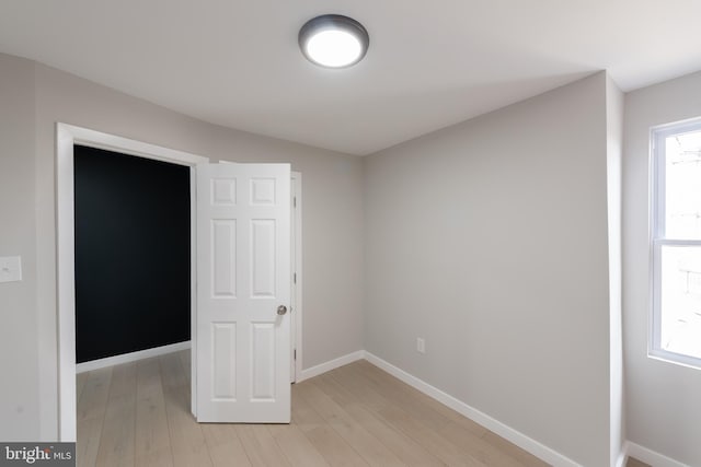 unfurnished bedroom with light wood-type flooring