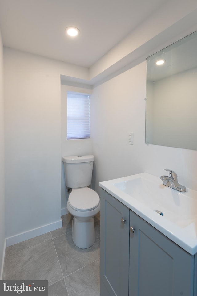 bathroom with tile patterned floors, vanity, and toilet