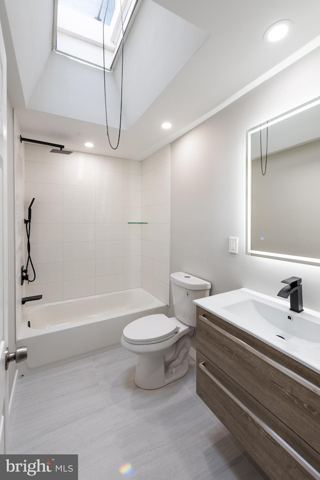 full bathroom featuring tile patterned flooring, vanity, toilet, and tiled shower / bath combo