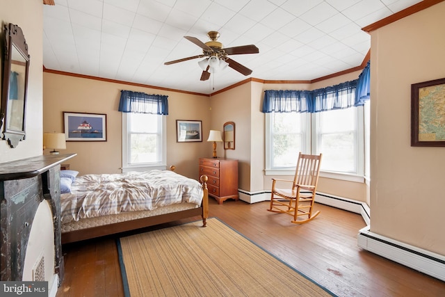 bedroom with hardwood / wood-style flooring, ceiling fan, crown molding, and multiple windows