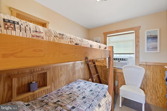 bedroom with cooling unit and wooden walls