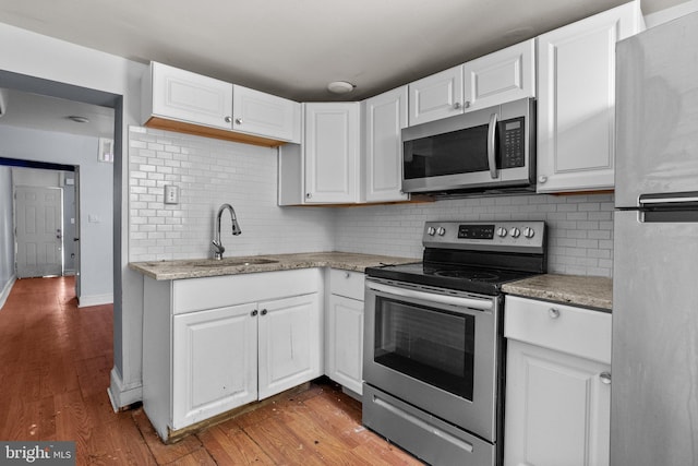 kitchen with white cabinets, sink, and appliances with stainless steel finishes