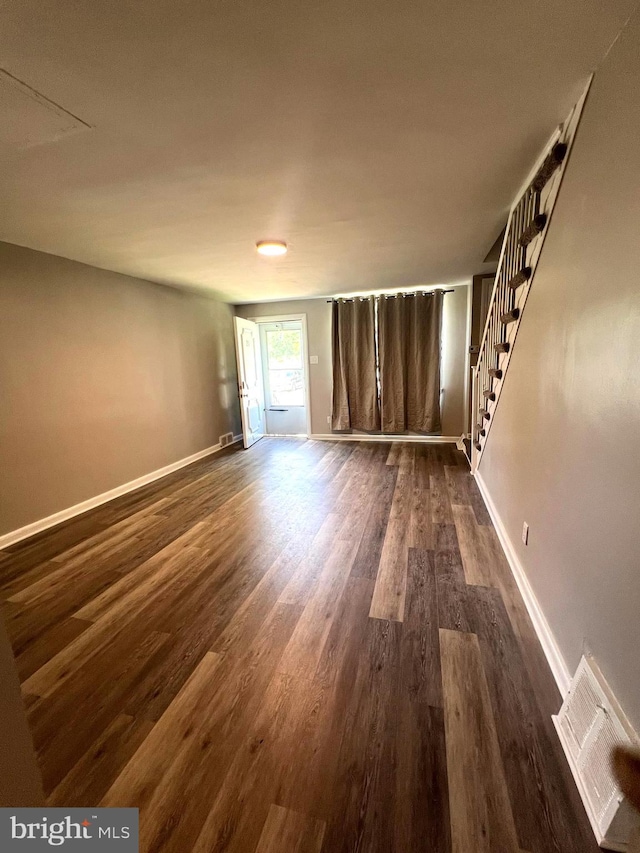 unfurnished room featuring dark wood-type flooring