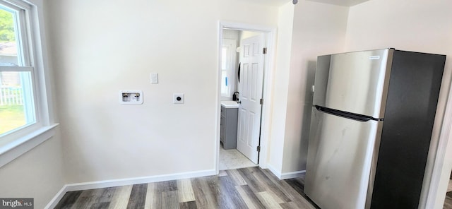 washroom featuring hookup for a washing machine, hookup for an electric dryer, and light hardwood / wood-style floors