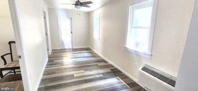 corridor featuring an AC wall unit, ornamental molding, and dark hardwood / wood-style floors