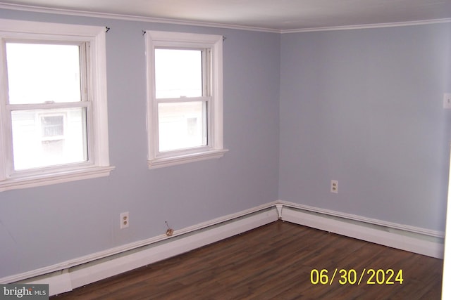 empty room with dark hardwood / wood-style flooring and crown molding