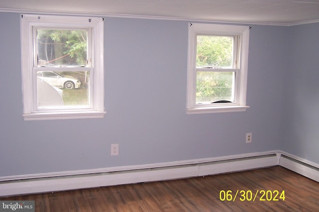 empty room with crown molding, a baseboard radiator, and dark hardwood / wood-style floors