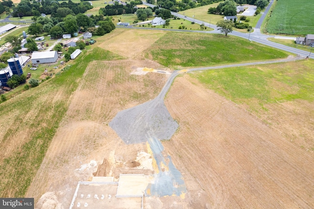 birds eye view of property with a rural view