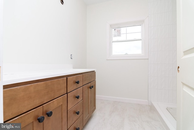 bathroom featuring a shower and vanity