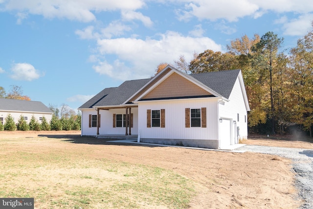 view of front of home featuring a porch and a garage