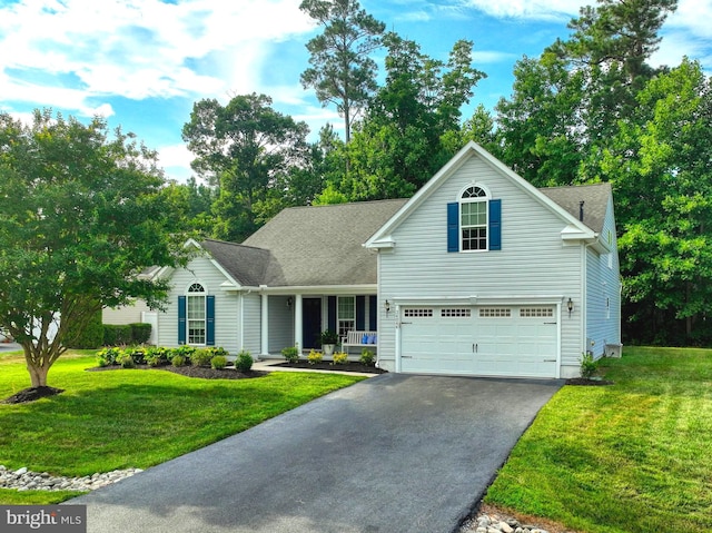 view of property featuring a porch, a garage, and a front yard