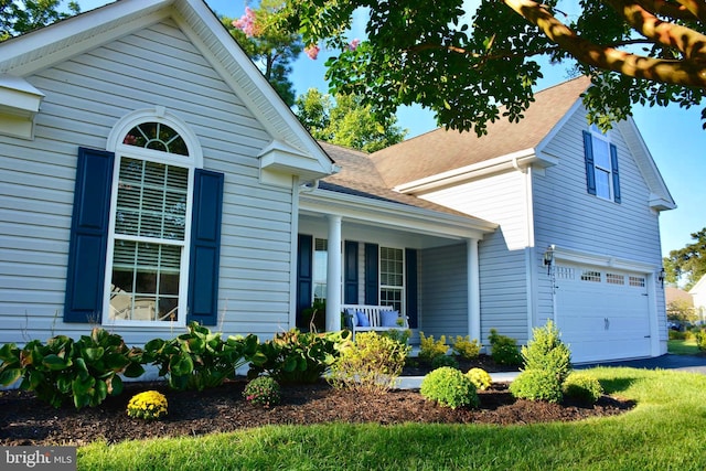 view of front of home featuring covered porch and a garage