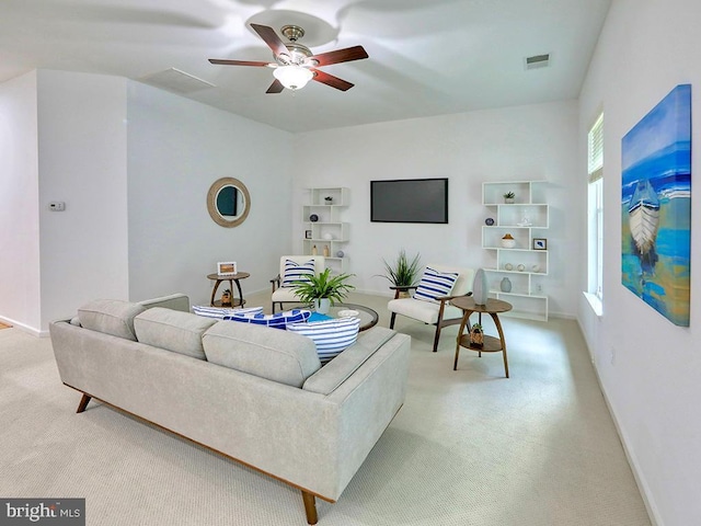 living room featuring ceiling fan and light colored carpet