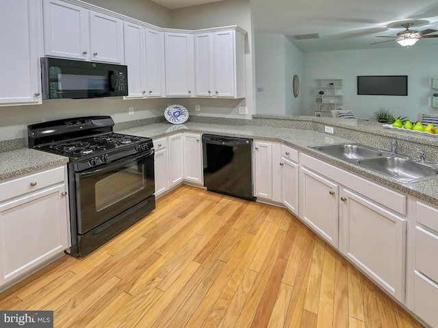 kitchen featuring light wood-type flooring, sink, white cabinetry, and black appliances