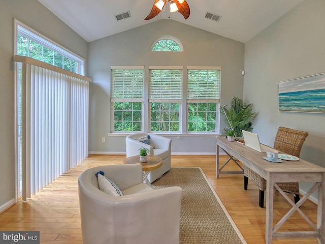 office space featuring ceiling fan, light wood-type flooring, and lofted ceiling