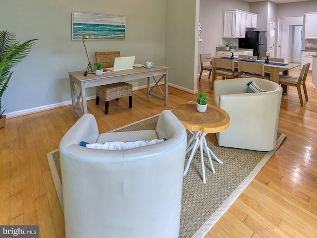 living room with light hardwood / wood-style flooring