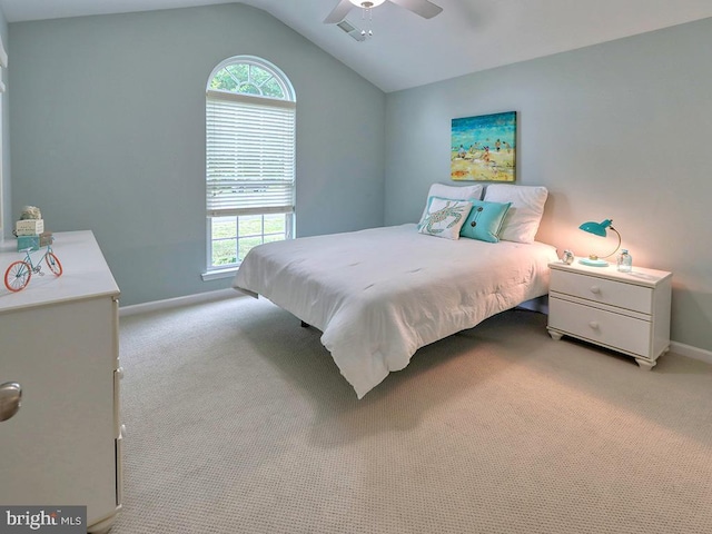 bedroom featuring multiple windows, light colored carpet, ceiling fan, and lofted ceiling