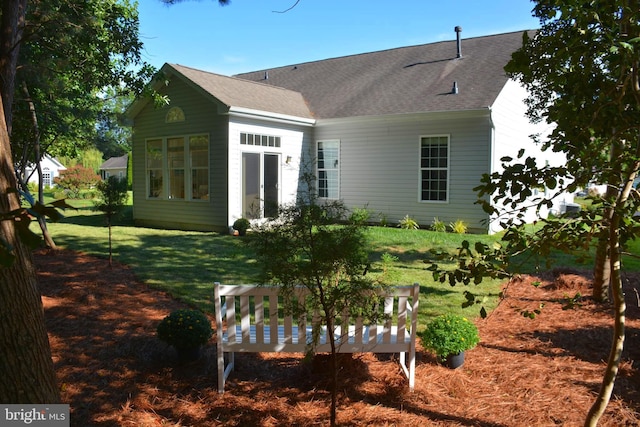 back of house with a yard