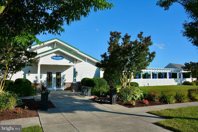 view of front of house featuring french doors and a front yard