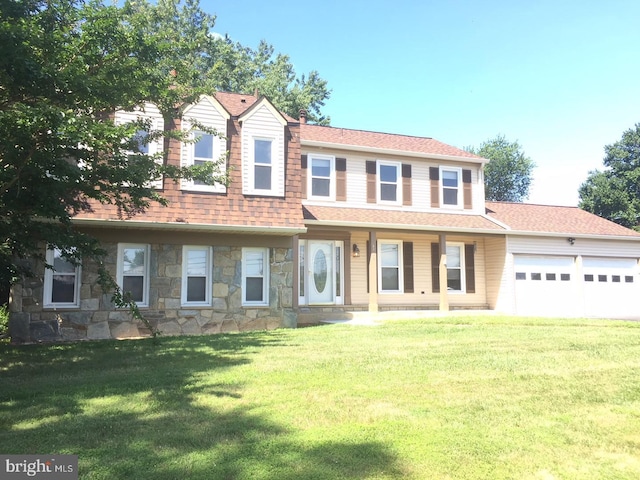 view of front facade with a garage and a front lawn