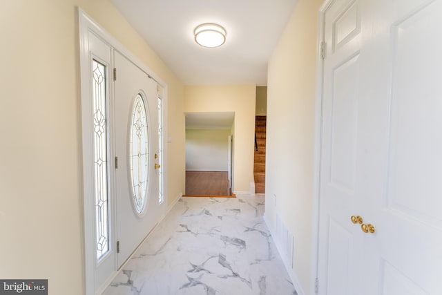 entryway with marble finish floor, visible vents, and baseboards