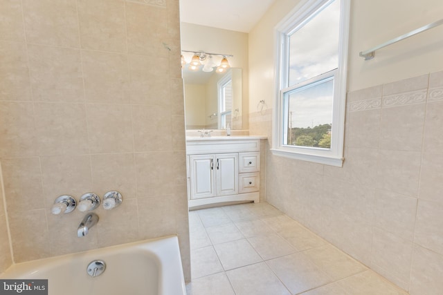 bathroom featuring vanity, tile patterned flooring, and tile walls