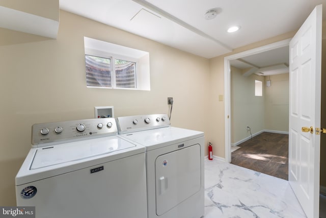 clothes washing area featuring laundry area, baseboards, marble finish floor, washer and dryer, and recessed lighting