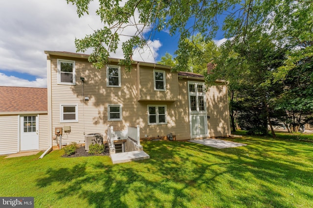 rear view of house with a lawn