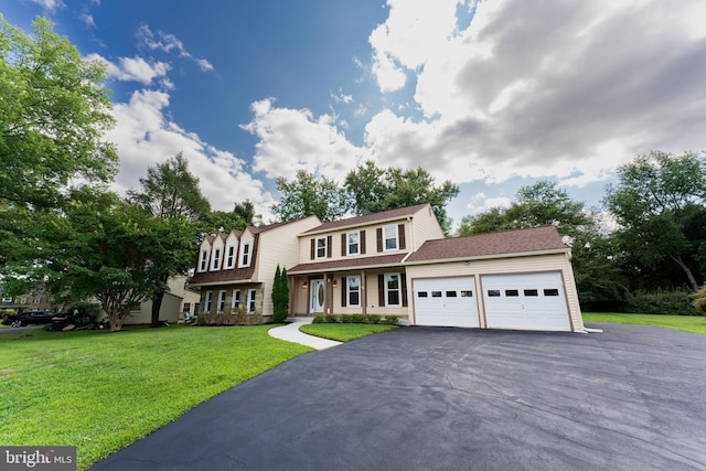 view of front facade with a garage, driveway, and a front yard